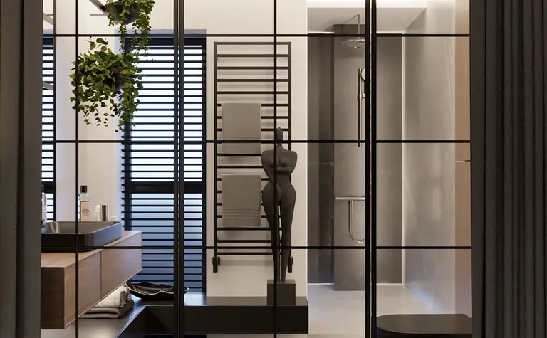 Nowoczesna łazienka z czarną wanną, minimalistycznym wystrojem i praktycznymi detalami