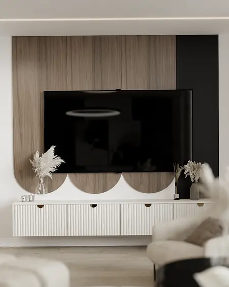 Wnętrze nowoczesnego salonu z telewizorem i drewnianą komodą.