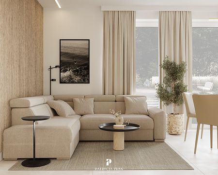 Wnętrze salonu w stylu japandi i minimalistycznym z beżową sofą.