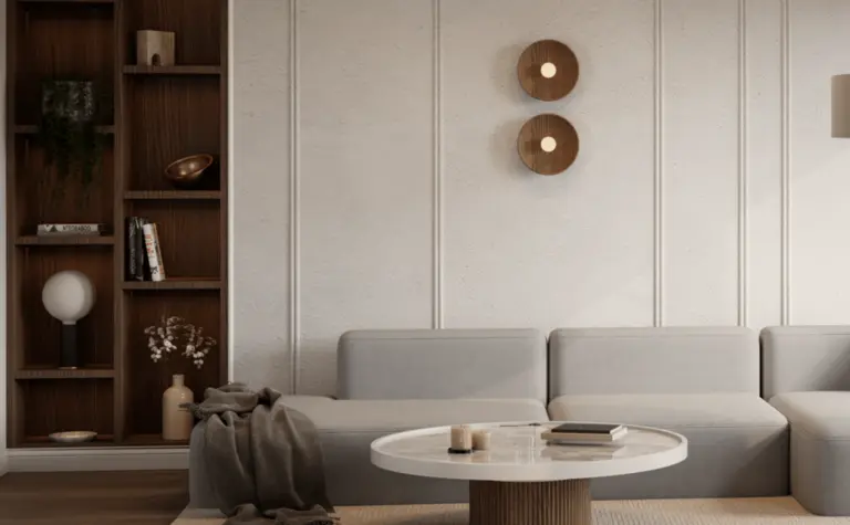 Wnętrze salonu w stylu skandynawskim i minimalistycznym z szarym narożnikiem i drewnianymi detalami.