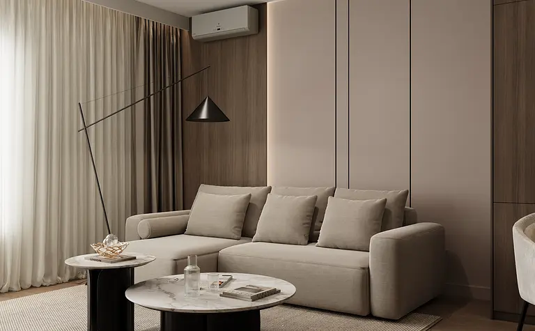 Wnętrze minimalistycznego salonu z beżową sofą, drewnianymi detalami i nowoczesnym oświetleniem.
