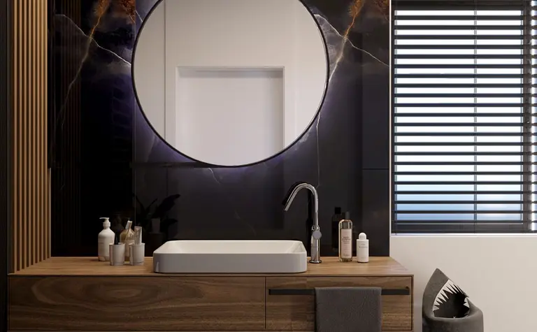 Nowoczesna łazienka z drewnianą szafką i okrągłym lustrem, minimalistyczny design, współczesny styl.