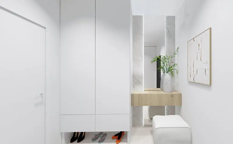 Przedpokój w stylu boho i japandi z białymi meblami i drewnianymi akcentami.