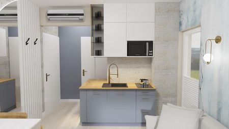 Wnętrze kuchni z szarymi meblami i drewnianym blatem, minimalistyczny design.