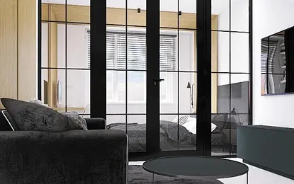 Wnętrze salonu z czarną sofą, szklanymi drzwiami i drewnianymi akcentami w stylu industrialnym.