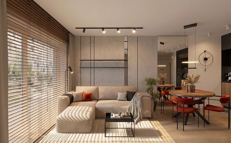 Wnętrze minimalistycznego salonu z beżową sofą, drewnianym stołem i roślinami.