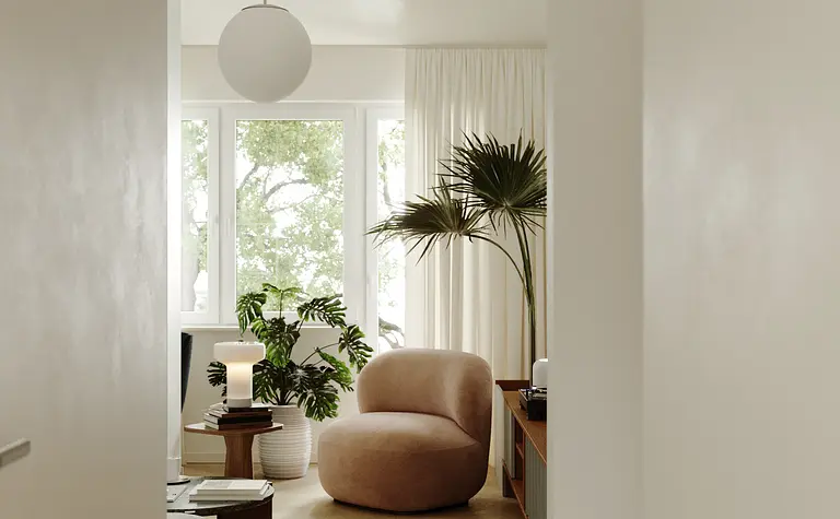 Wnętrze w stylu industrialnym, minimalistycznym z różowym fotelem i roślinami.