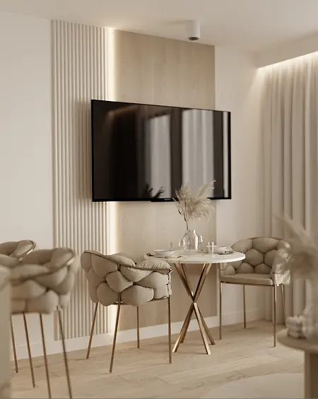 Wnętrze jadalni z jasnymi meblami, drewnianym stołem i nowoczesnym telewizorem.