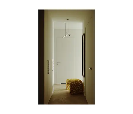 Przedpokój w stylu industrialnym i minimalistycznym z białymi ścianami i żółtym pufem.