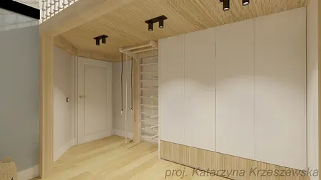 Garderoba z białymi meblami i drewnianym wykończeniem w nowoczesnym stylu.