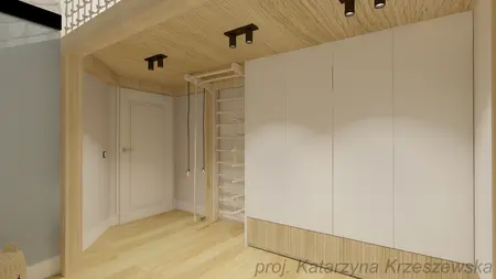 Garderoba z białymi meblami i drewnianym wykończeniem w nowoczesnym stylu.
