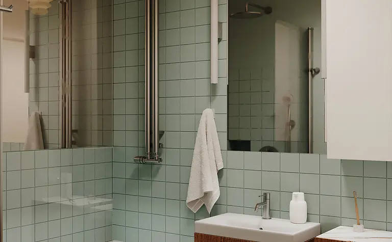 Nowoczesna łazienka z zielonymi płytkami, drewnianymi meblami, oświetleniem i lustrem.