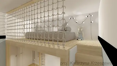 Wnętrze poddasza z jasnym wystrojem i meblami, idealne dla dzieci.