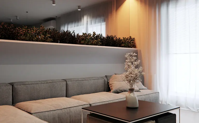 Eklektyczny minimalistyczny salon z szarymi meblami i roślinami.