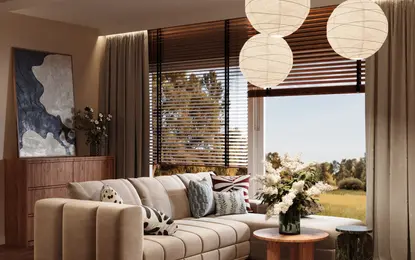 Wnętrze salonu w stylu dopamine decor, eklektycznym i współczesnym z beżową sofą.