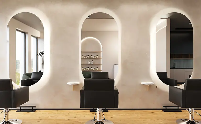 Wnętrze salonu fryzjerskiego w stylu boho i japandi z czarnymi fotelami i jasnymi ścianami.