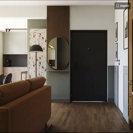 Przedpokój z brązową sofą, nowoczesnymi akcentami i lustrem w stylu dopamine decor.