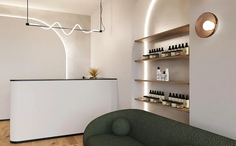 Recepcja z białym blatem, zieloną sofą i półkami w stylu boho i japandi.