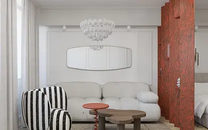 Wnętrze salonu w stylu art deco i tradycyjnym z białą sofą i czerwonym stolikiem.