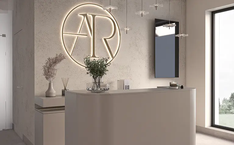 Nowoczesna recepcja z minimalistycznym blatem, oświetleniem i dekoracjami.