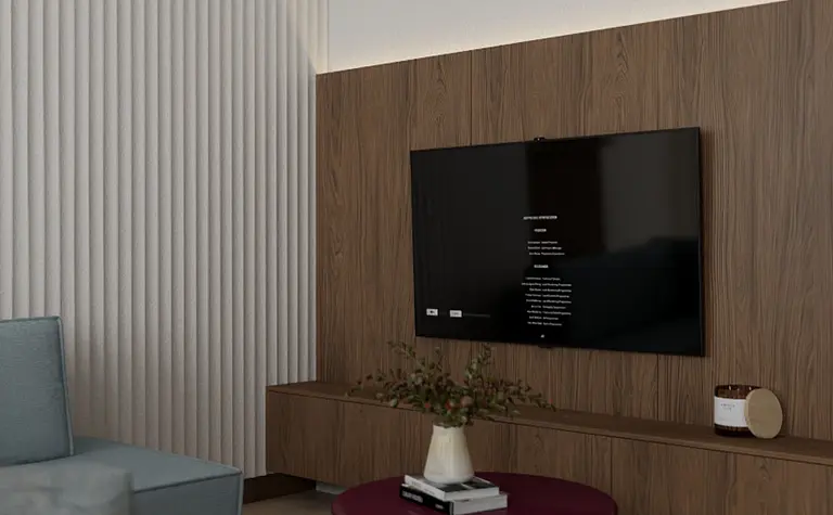 Współczesny salon z telewizorem, drewnianą ścianą i okrągłym stolikiem.