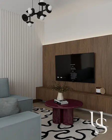 Współczesny salon z telewizorem, drewnianą ścianą i okrągłym stolikiem.