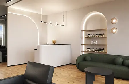 Wnętrze biura w stylu boho i japandi z białym biurkiem i zieloną sofą.