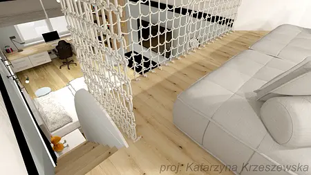 Wnętrze z nowoczesnym biurkiem, jasnym sofą i drewnianą podłogą.