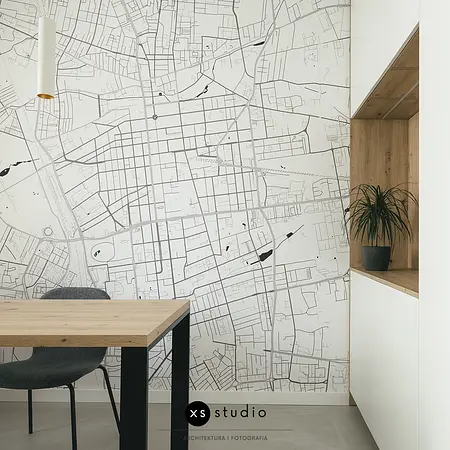 Wnętrze jadalnii w stylu minimalistycznym i skandynawskim z mapą i rośliną