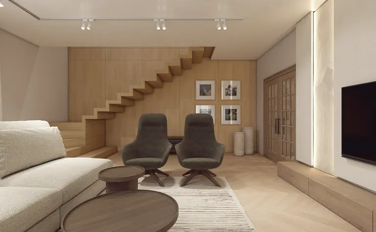 Wnętrze salonu z drewnianymi schodami, beżową sofą i zielonymi fotelami w stylu minimaluxe.