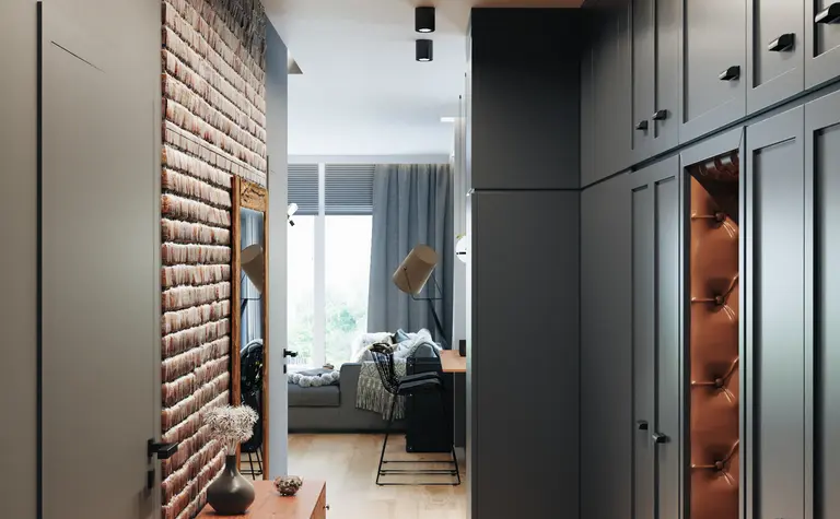Przedpokój w stylu industrialnym i soft minimalizm z drewnianą podłogą i szafkami.