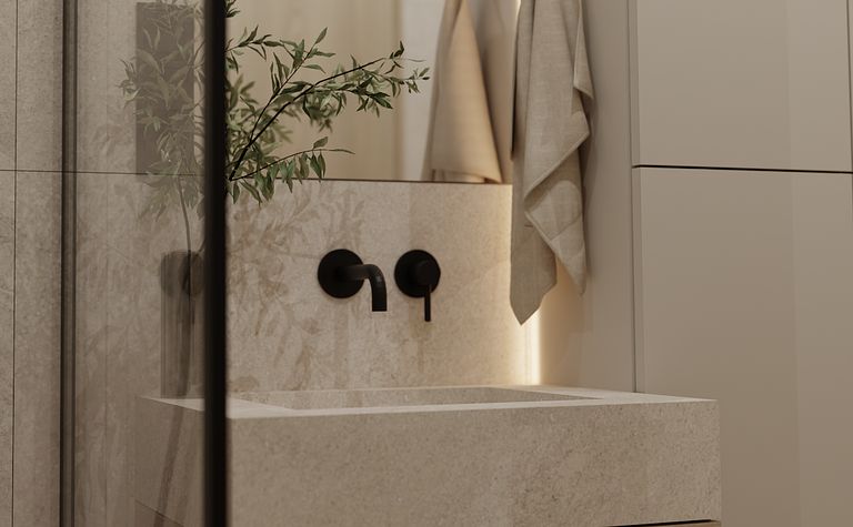 Wnętrze nowoczesnej łazienki z szarymi płytkami, drewnianą szafką i czarnymi detalami.