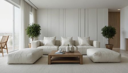 Minimalistyczny salon z białymi meblami i drzewkami w doniczkach