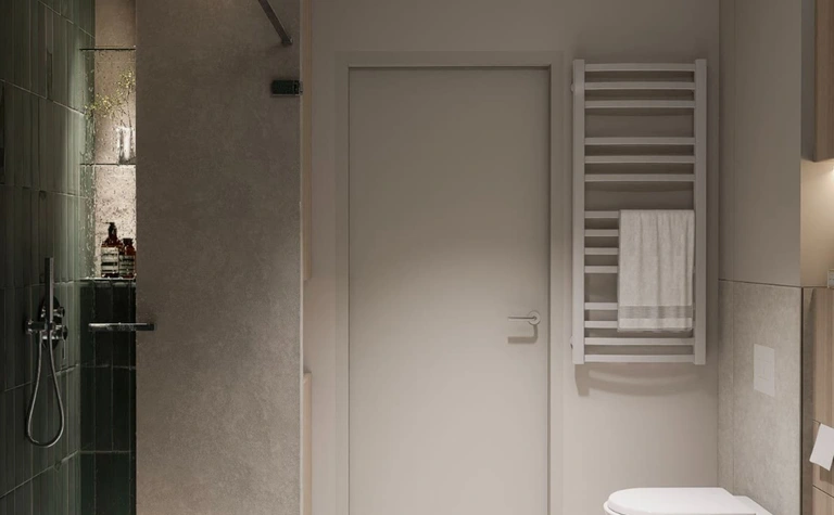 Wnętrze nowoczesnej łazienki z zieloną płytką, minimalistycznymi detalami i soft minimalizmem.