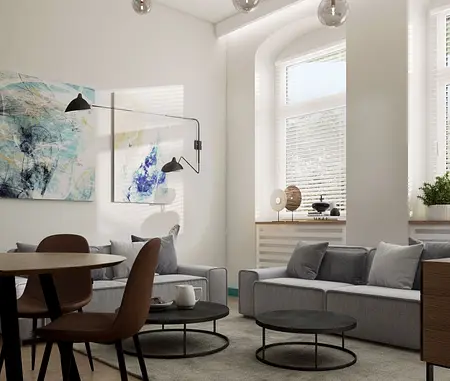 Nowoczesny salon w stylu eklektycznym z szarymi kanapami, okrągłymi stolikami i dużymi oknami.