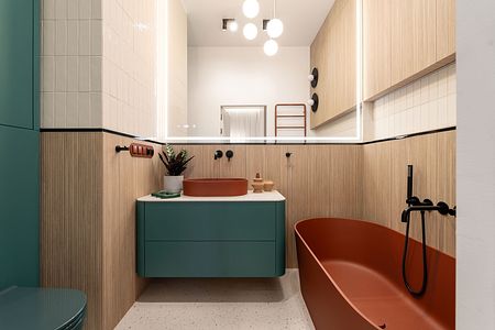 Nowoczesna łazienka z zielonymi meblami i brązową wanną, współczesny design.