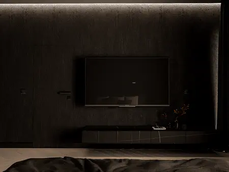 Nowoczesny salon z czarną ścianą, telewizorem i minimalistycznymi akcentami.