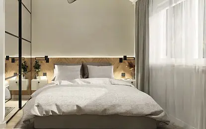 Nowoczesna sypialnia z podświetlanym zagłówkiem w jodełkę, dużym lustrem, zasłonami, wygodnym łóżkiem i minimalistycznym oświetleniem