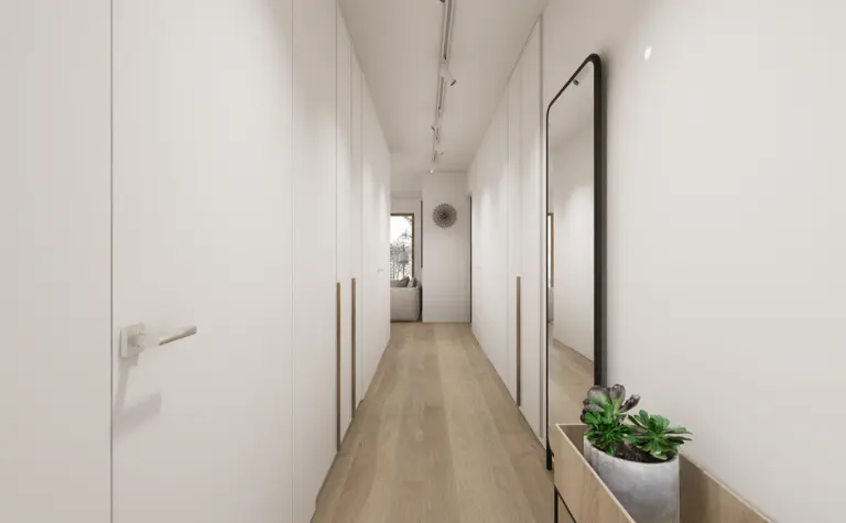 Przedpokój w stylu japandi i minimalistycznym z białymi ścianami i drewnianą podłogą.