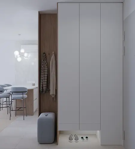 Garderoba z białymi meblami, drewnianymi detalami i oświetleniem.