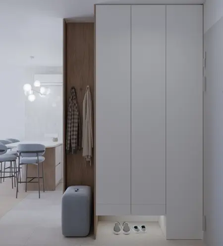 Garderoba z białymi meblami, drewnianymi detalami i oświetleniem.