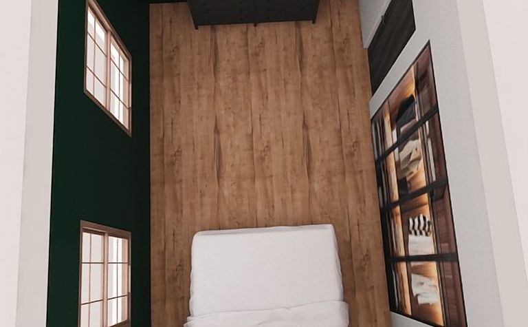 Wnętrze sypialni z zielonymi ścianami, drewnianą podłogą i białym łóżkiem