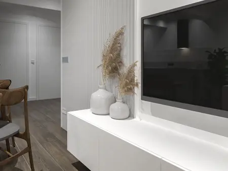 Nowoczesne wnętrze z białą szafką, telewizorem i roślinami