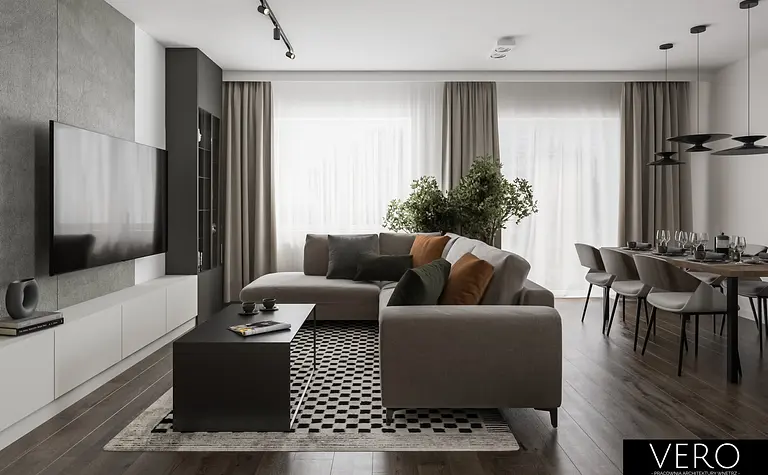 Wnętrze nowoczesnego salonu z minimalistycznym designem, szarymi meblami i zielonymi roślinami.