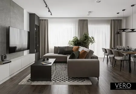 Wnętrze nowoczesnego salonu z minimalistycznym designem, szarymi meblami i zielonymi roślinami.