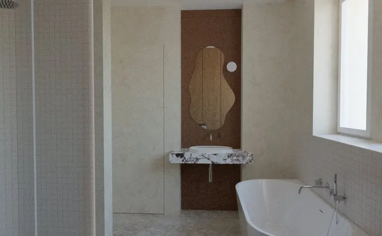 Wnętrze łazienki w stylu minimalistycznym z marmurową umywalką i wanną.