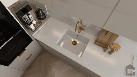 Kuchnia z białymi meblami, złotym kranem i akcesoriami.