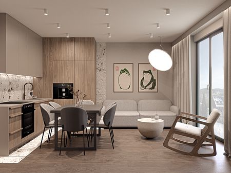 Wnętrze nowoczesnej kuchni z drewnianymi akcentami i szarym stołem.