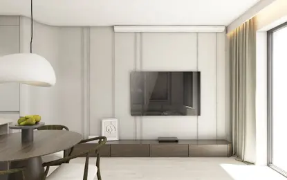 Wnętrze salonu z nowoczesnym telewizorem, jasnymi meblami i dodatkami w stylu boho, japandi oraz minimalistycznym.