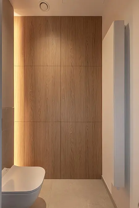 Minimalistyczna toaleta z drewnianymi panelami i białymi elementami.